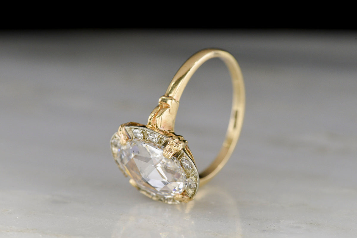 Belle Époque Yellow Gold Ring featuring an Oval Rose Cut Diamond Center with a White Gold and Diamond Surround