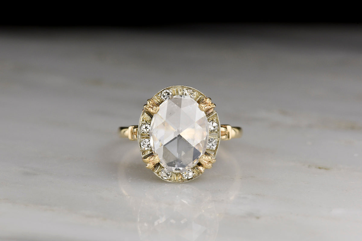 Belle Époque Yellow Gold Ring featuring an Oval Rose Cut Diamond Center with a White Gold and Diamond Surround