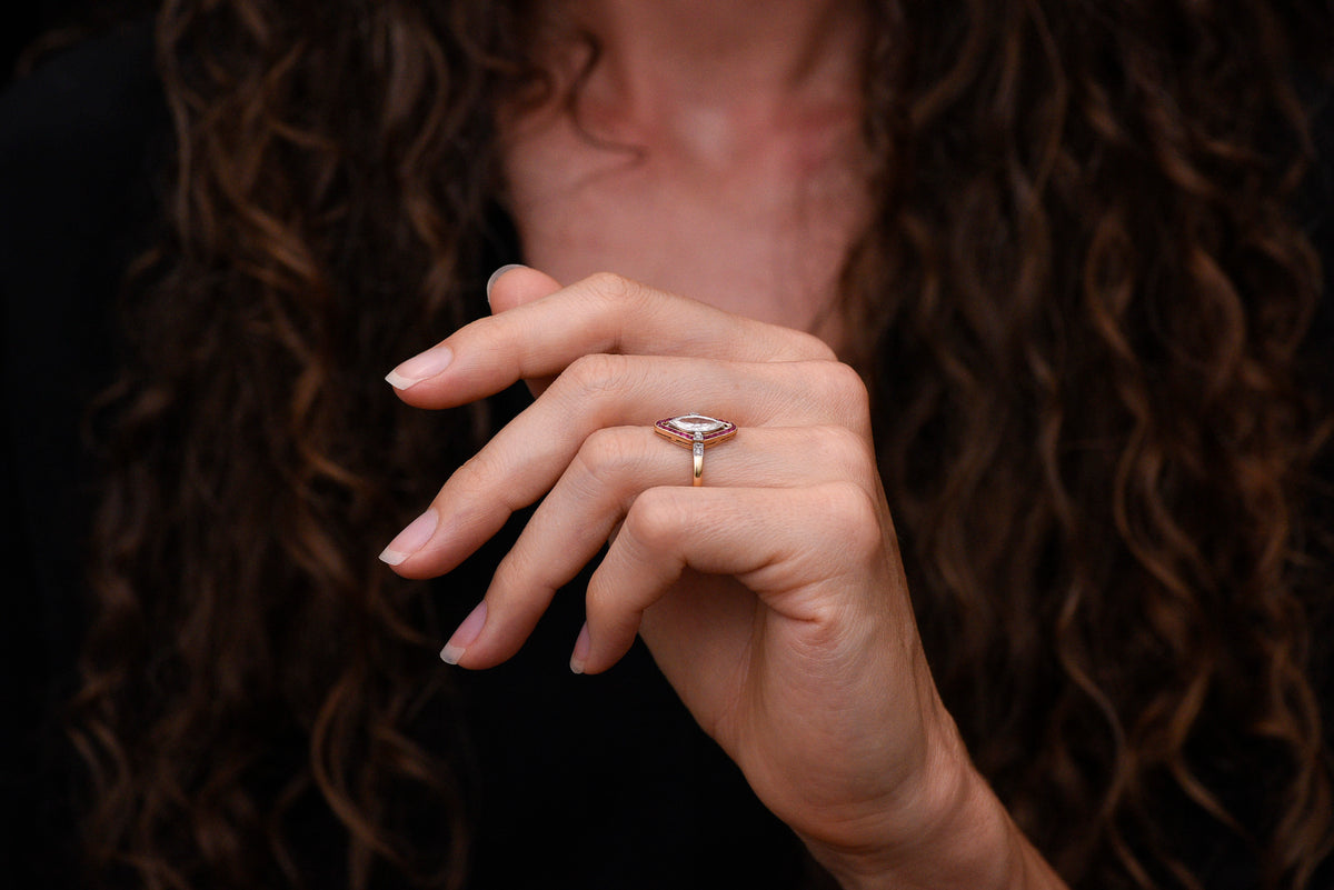 Shauna&#39;s Secret Stash: c. Early 1900s Belle Époque Two-Tone Ring with a Floating Marquise Cut Diamond and Ruby Surround