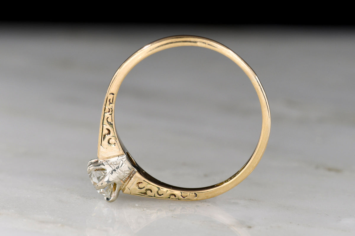 Late Victorian Petite Gold Solitaire with Ornamented Shoulders and an Early Transitional Cut Diamond