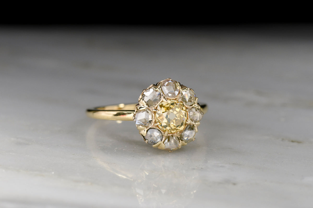 Mid-Late 1800s Cluster Ring with a Fancy Yellow Old Mine Cut Diamond Center