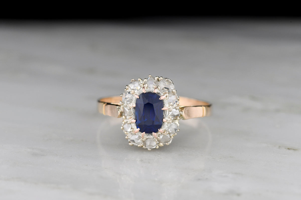 Late 1800s Victorian Cluster Ring with an Elongated Cushion Sapphire and Rose Cut Diamonds