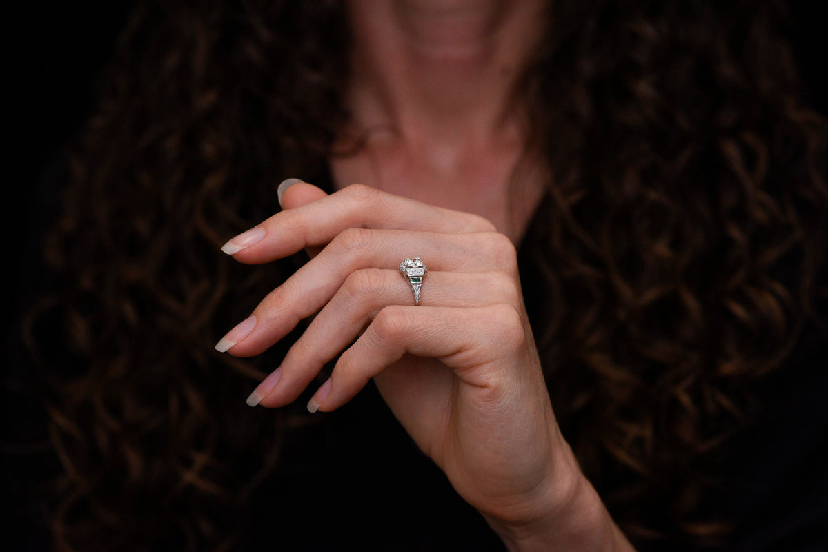 Art Deco Engagement Ring with Stepwise Graduation, Balustrade Gallery, and Emerald Accents