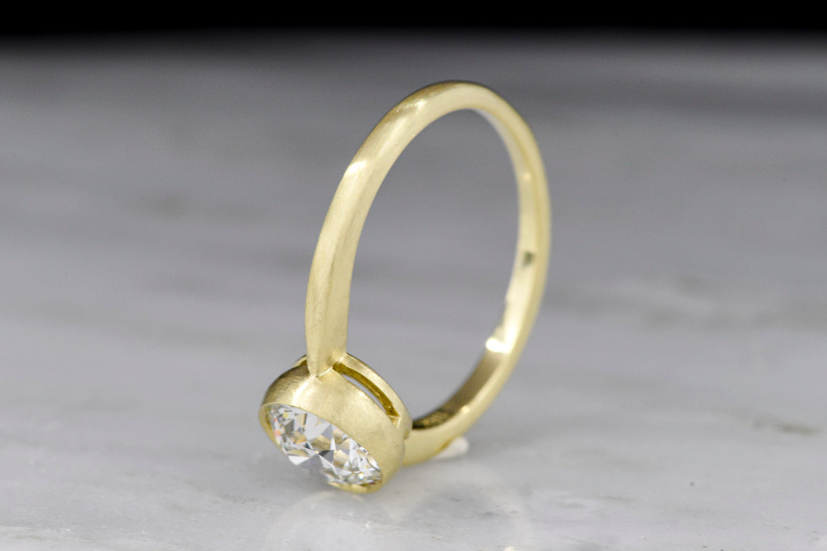 Pebble &amp; Polish Original: Classic Solitaire in 18K with a Rounded Top and Peek-a-Boo Basket