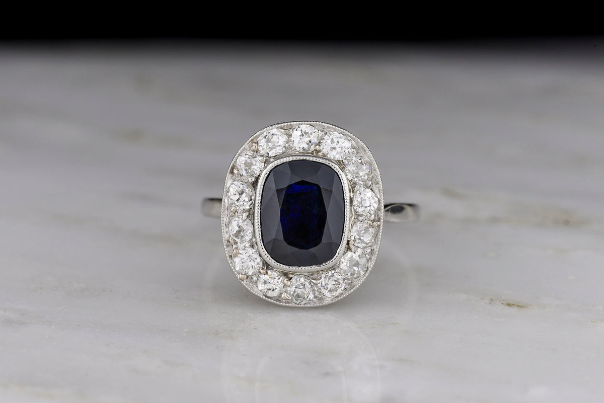 French Early Art Deco Platinum Sapphire and Diamond Cluster Ring with Hand-Pierced Metalwork