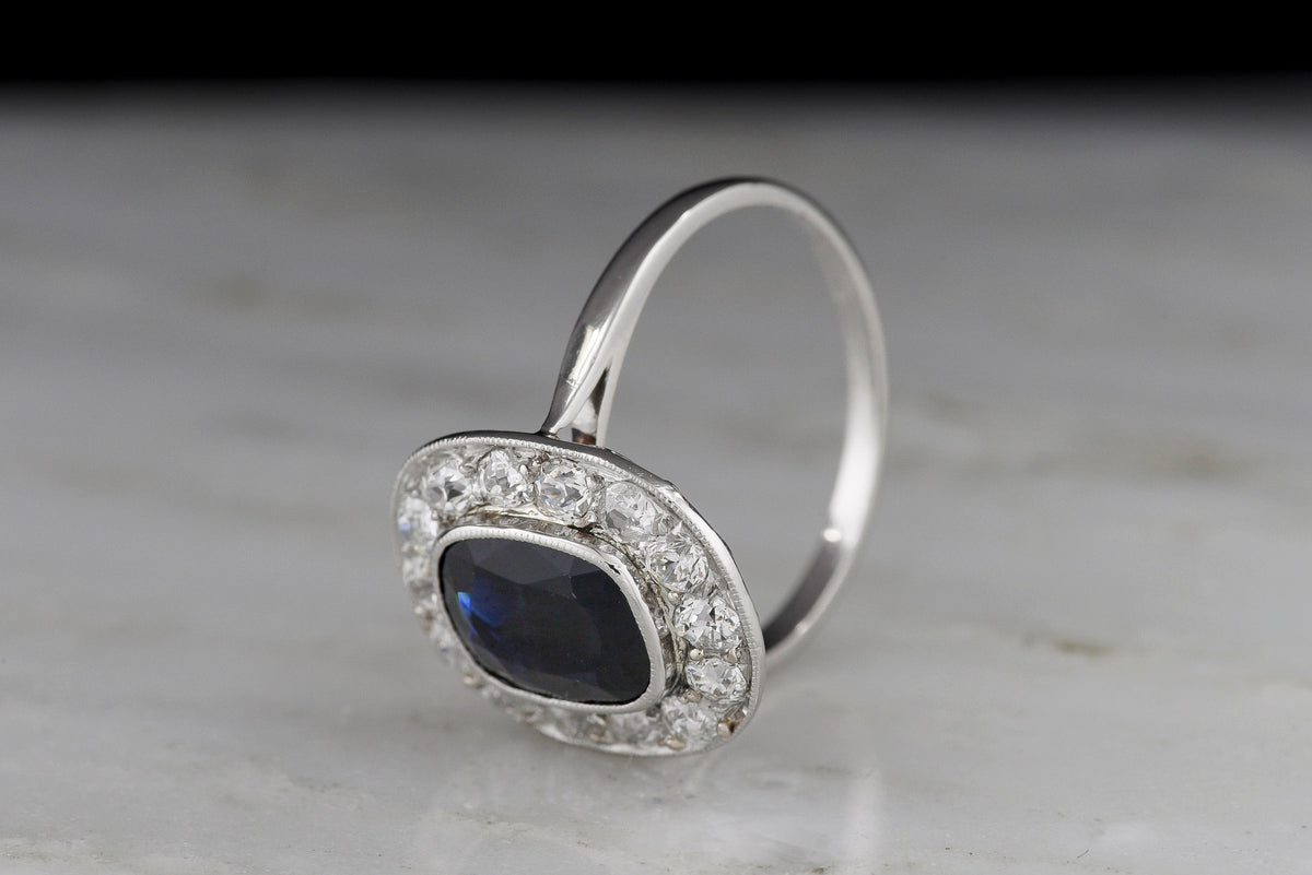 French Early Art Deco Platinum Sapphire and Diamond Cluster Ring with Hand-Pierced Metalwork