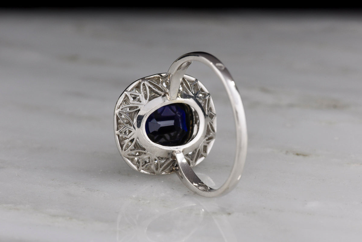 French Early Art Deco Platinum Sapphire and Diamond Cluster Ring with Hand-Pierced Metalwork