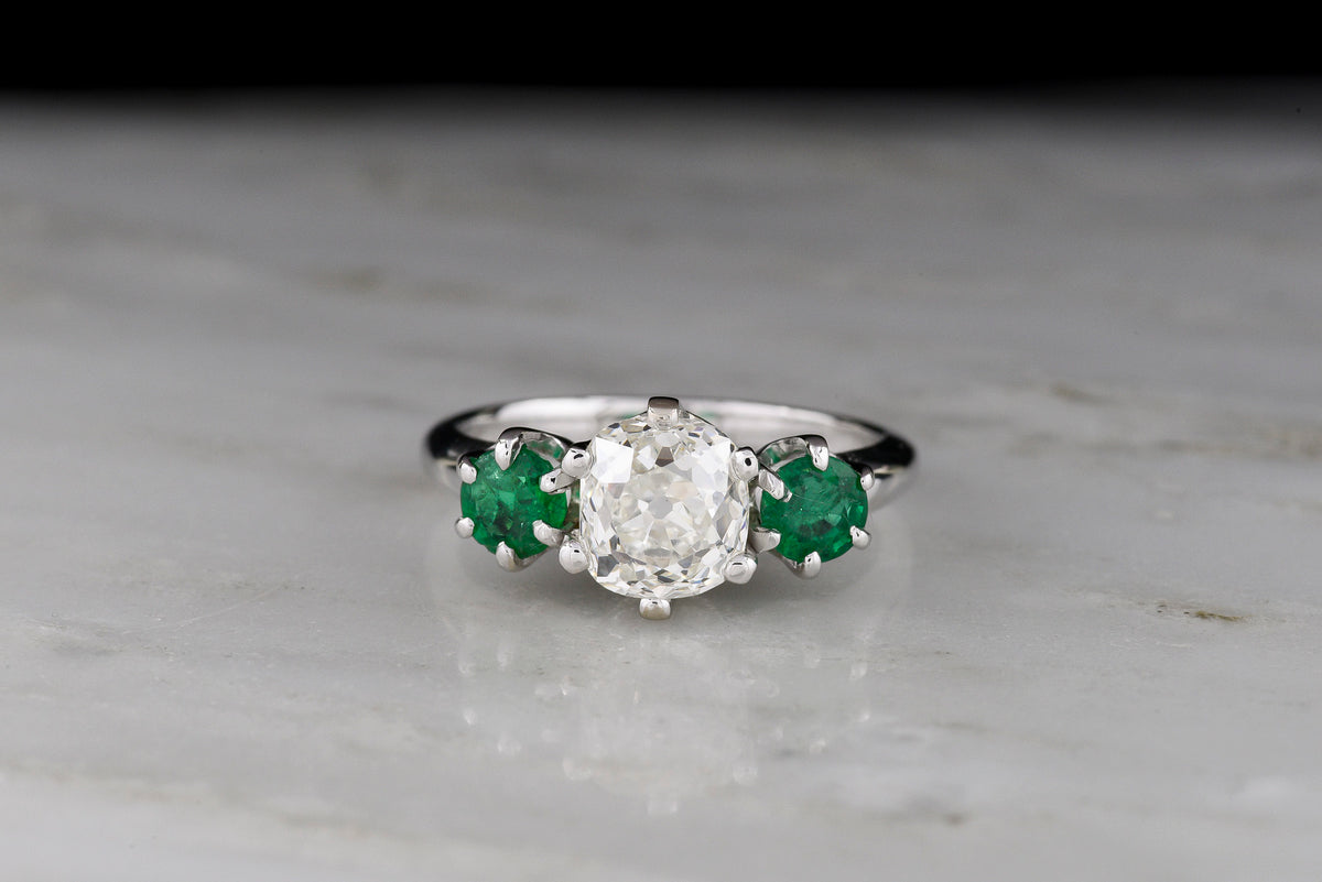 Vintage Three Stone Engagement Ring with a 1.68 Carat Old Mine Cut Diamond and Two Round Emeralds