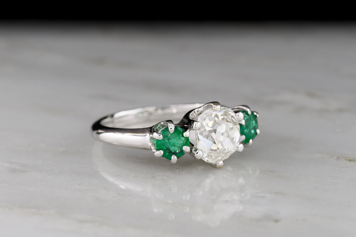 Vintage Three Stone Engagement Ring with a 1.68 Carat Old Mine Cut Diamond and Two Round Emeralds