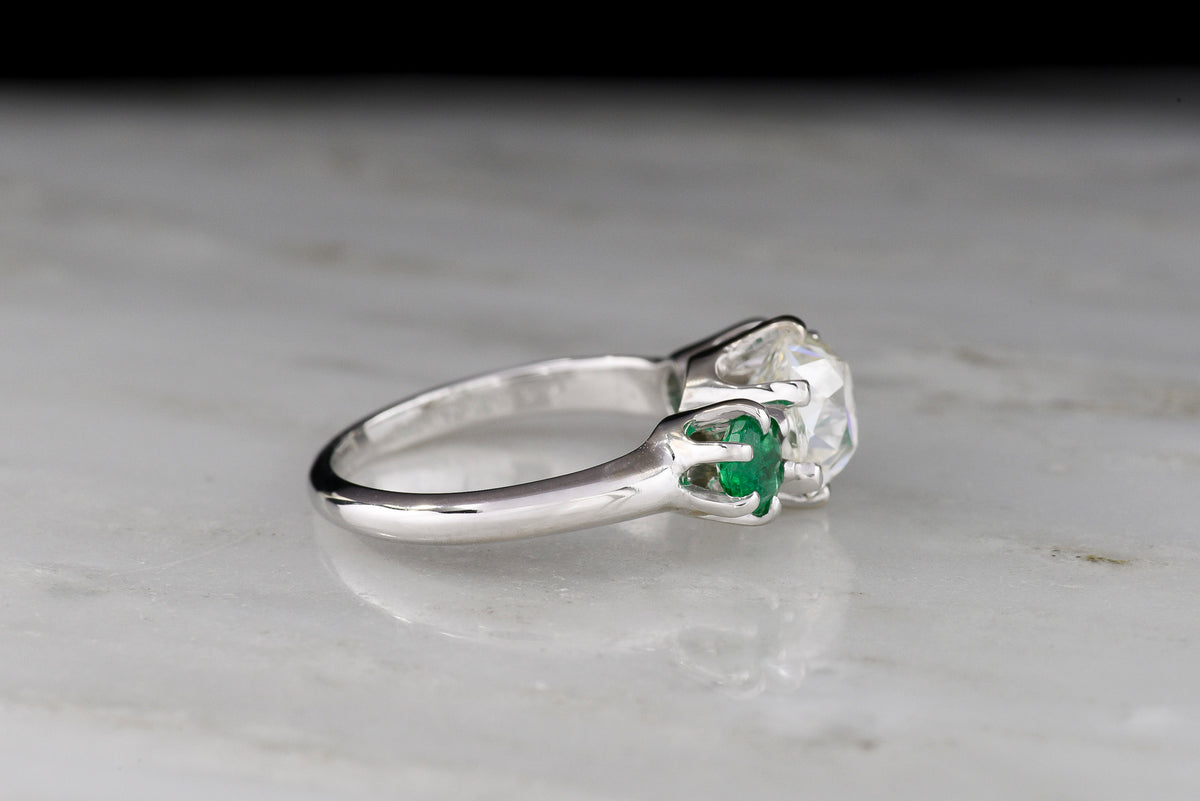 Vintage Three Stone Engagement Ring with a 1.68 Carat Old Mine Cut Diamond and Two Round Emeralds