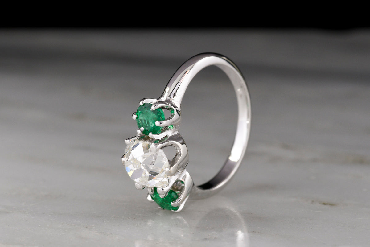 Vintage Three Stone Engagement Ring with a 1.68 Carat Old Mine Cut Diamond and Two Round Emeralds