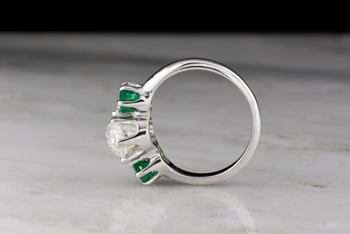 Vintage Three Stone Engagement Ring with a 1.68 Carat Old Mine Cut Diamond and Two Round Emeralds