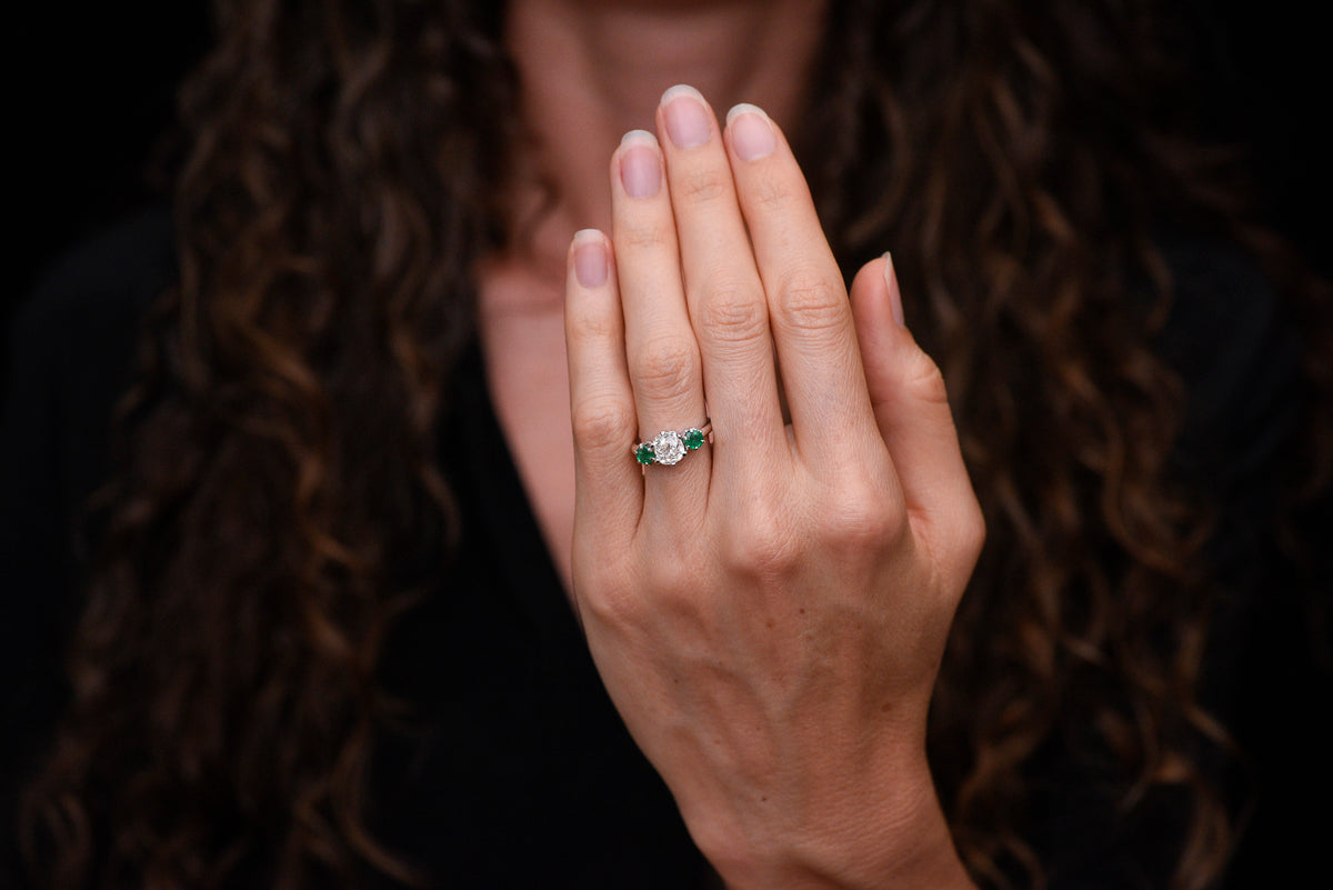 Vintage Three Stone Engagement Ring with a 1.68 Carat Old Mine Cut Diamond and Two Round Emeralds