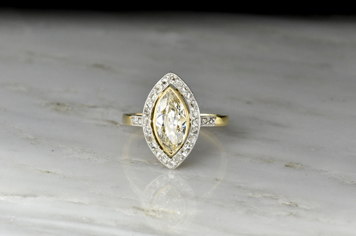 Belle Époque Gold and Platinum Ring with a Marquise Cut Diamond Center