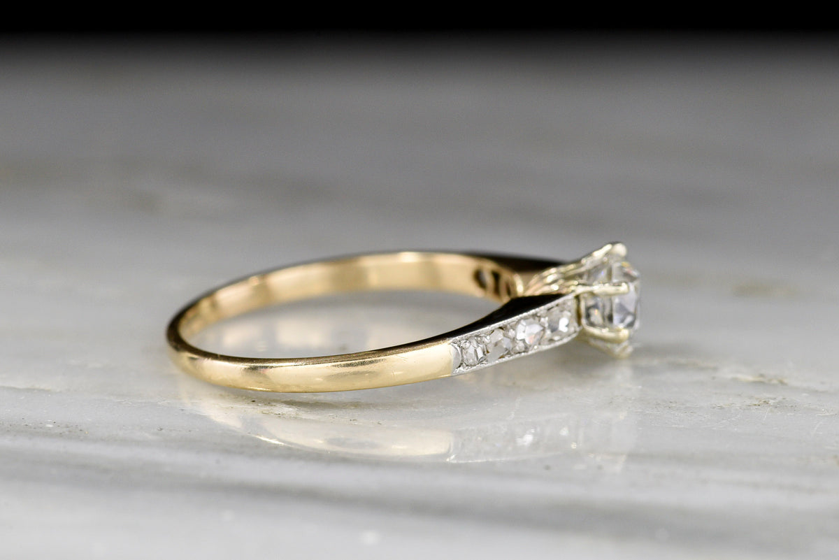 c. 1900s Gold and Platinum Ring with an Old European Cut Diamond Center and Antique Rose Cut Accents