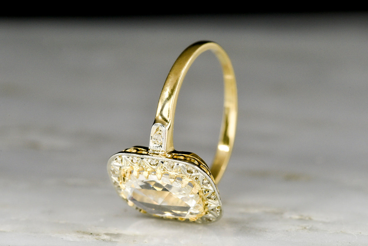 Late Belle Époque Gold and Platinum Ring with an Oval Rose Cut Diamond Center