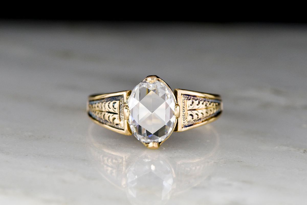 Mid-Late 1800s Gold Ring with Carved Shoulders and a Colorless Oval Rose Cut Diamond Center