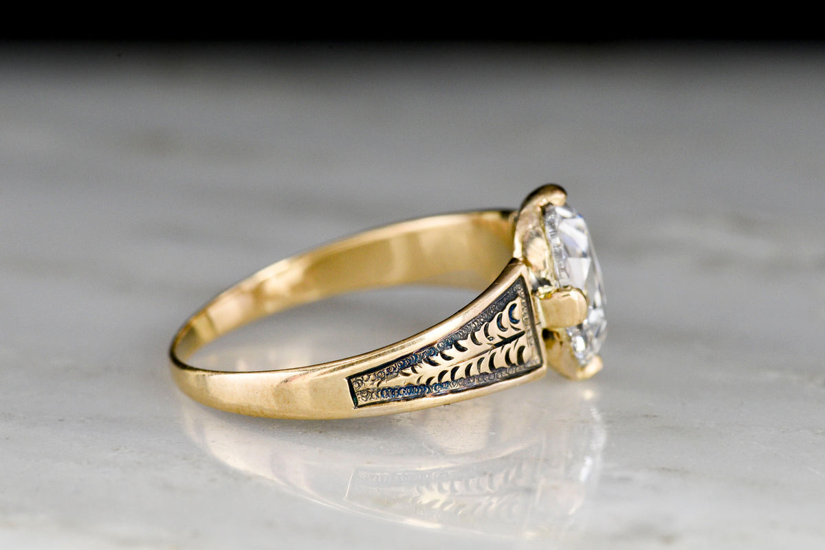 Mid-Late 1800s Gold Ring with Carved Shoulders and a Colorless Oval Rose Cut Diamond Center