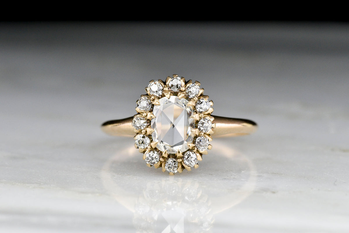 Victorian Faint Rose Gold Cluster Ring with an Oval Rose Cut Diamond Center