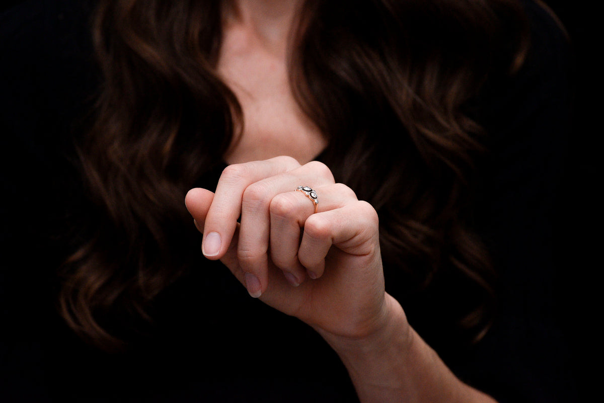 Belle Époque Gold and Platinum Ring with a Unique Floating Three-Stone Bezel Design