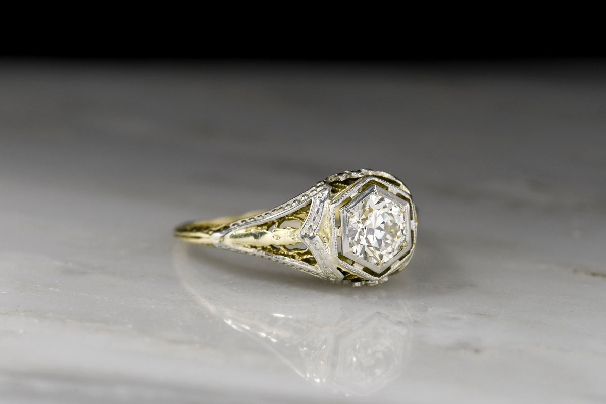 Late Belle Époque Yellow and White Gold Ring with Ornate Metalwork and a Transitional Cut Diamond