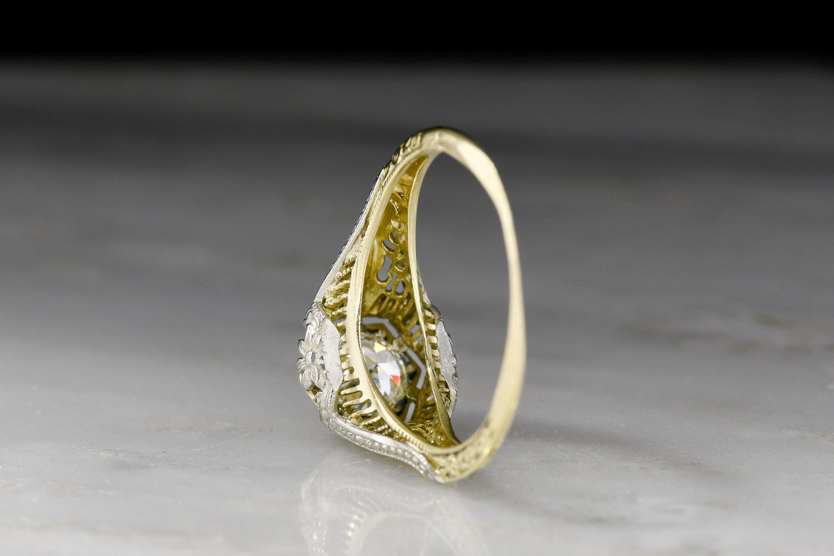 Late Belle Époque Yellow and White Gold Ring with Ornate Metalwork and a Transitional Cut Diamond