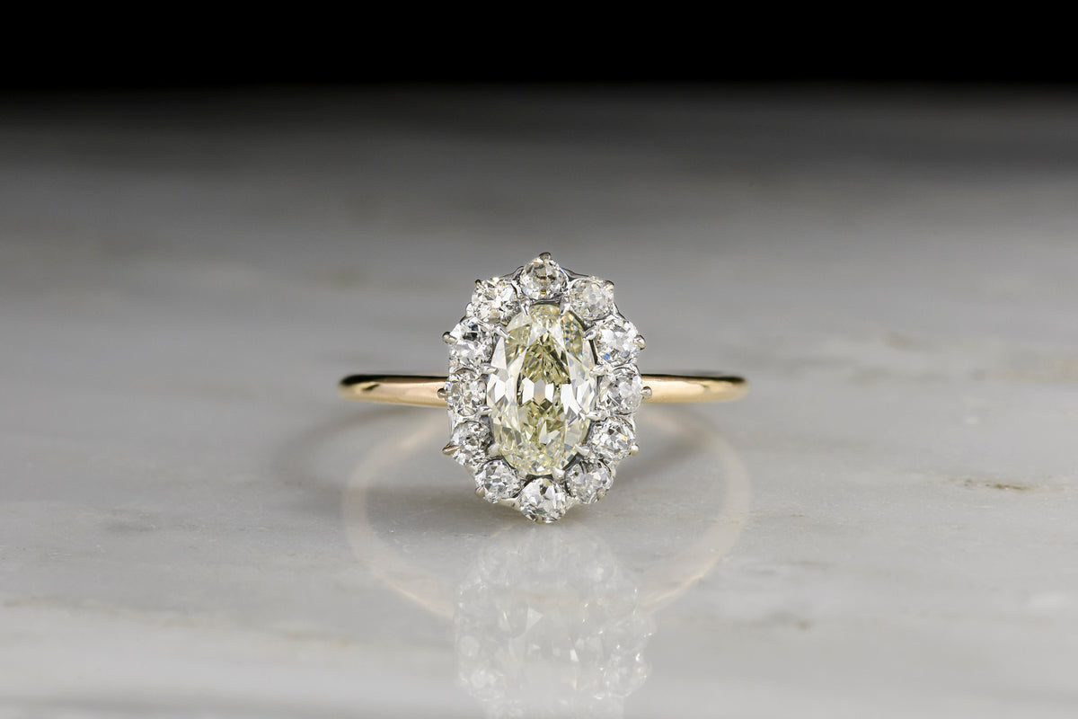 18K Gold and Platinum Cluster Ring with a GIA Oval Cut Diamond Center