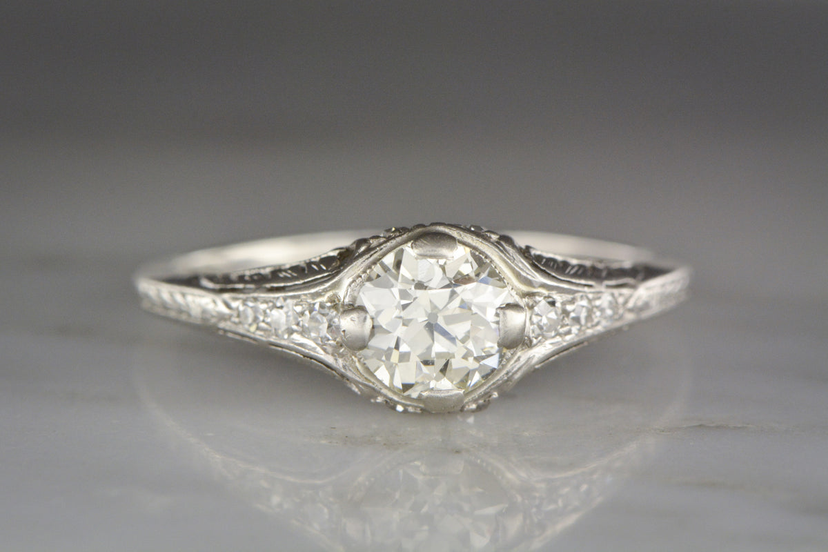 .75 Carat Old European Cut Diamond in a c. 1910s Edwardian / Art Deco Platinum Engagement Ring with Diamond Accents and Floral Engraving / Filigree