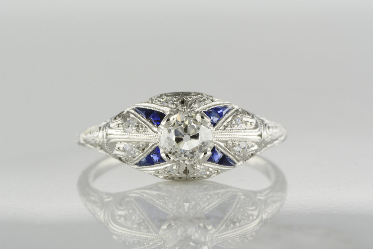 1910s-1920s Edwardian / Art Deco Platinum Engagement Ring with .37 Carat Old Mine Cut Diamond Center and .50 ctw Diamond and Sapphire Accents
