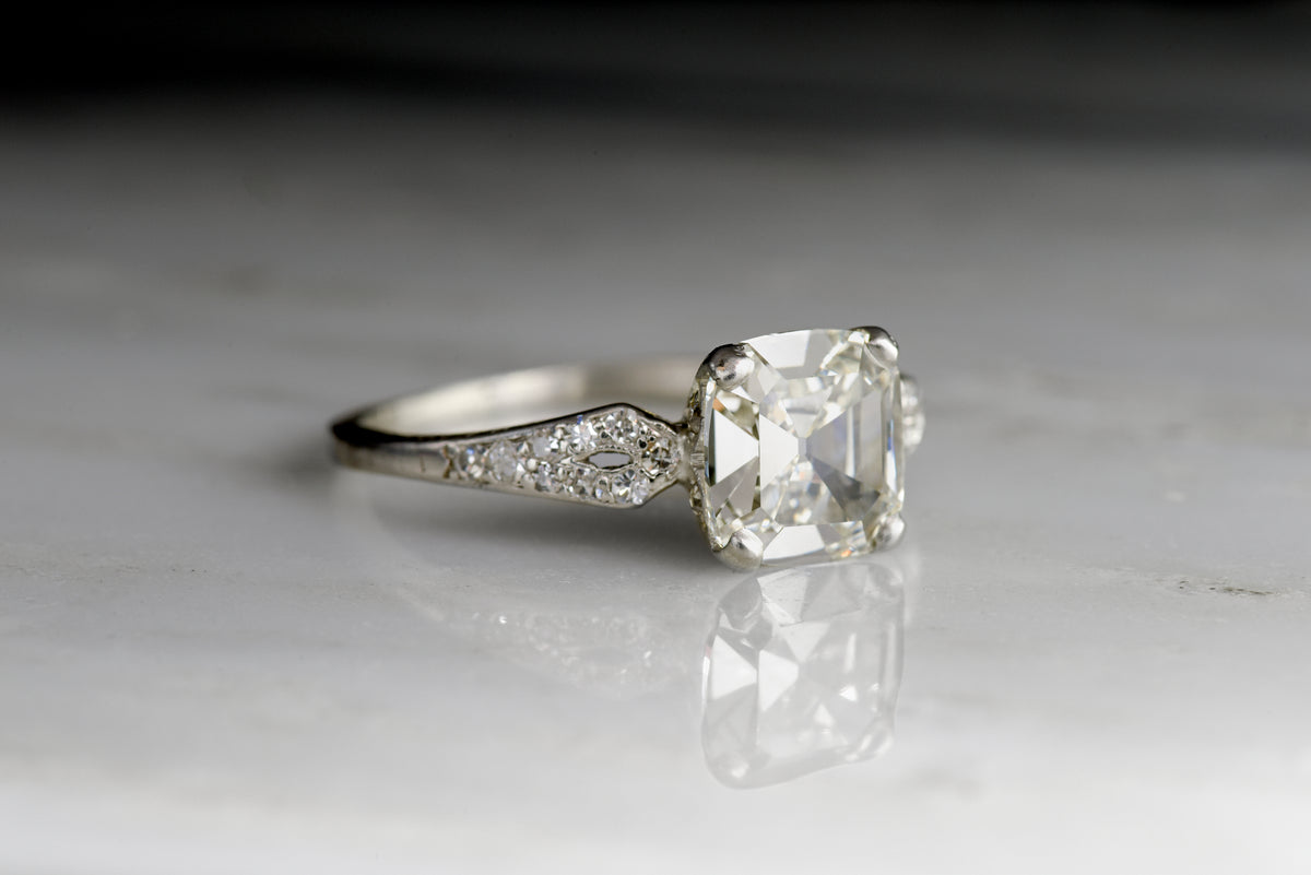 Late Edwardian Engagement Ring with a 1.68 Carat Old Step Cut Diamond Center