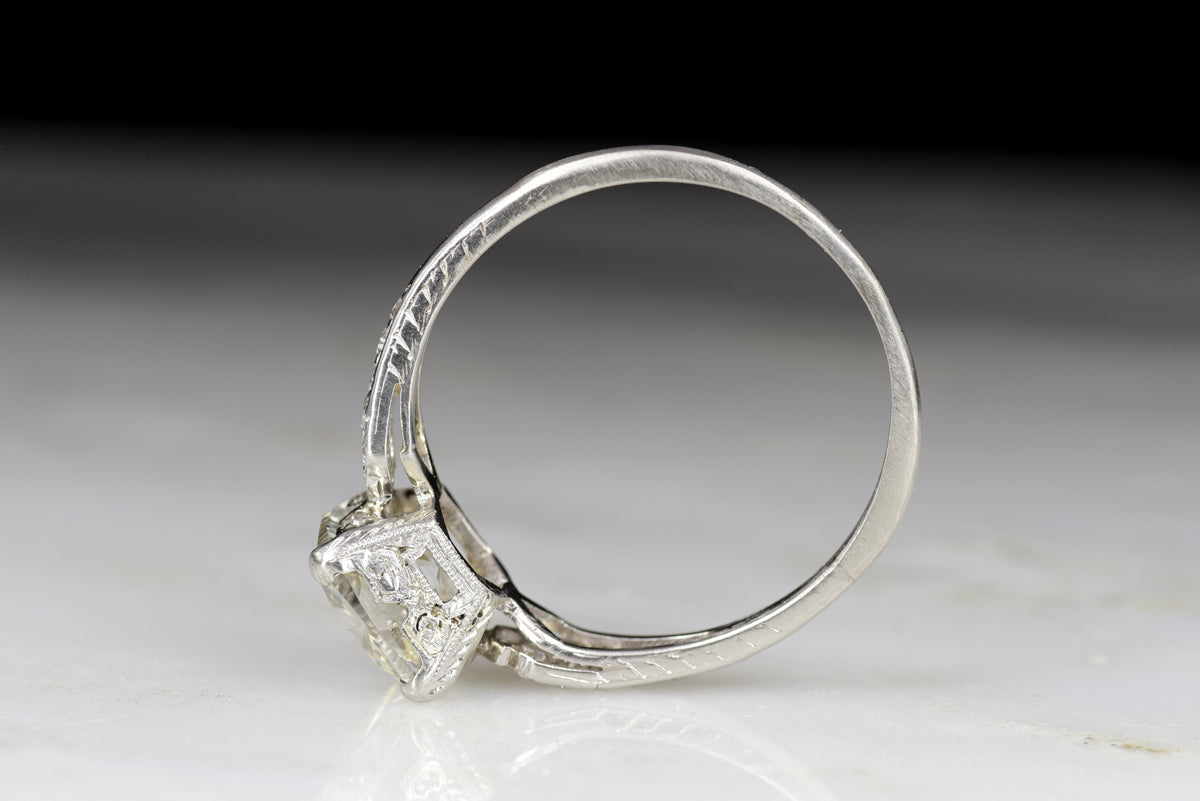 Late Edwardian Engagement Ring with a 1.68 Carat Old Step Cut Diamond Center