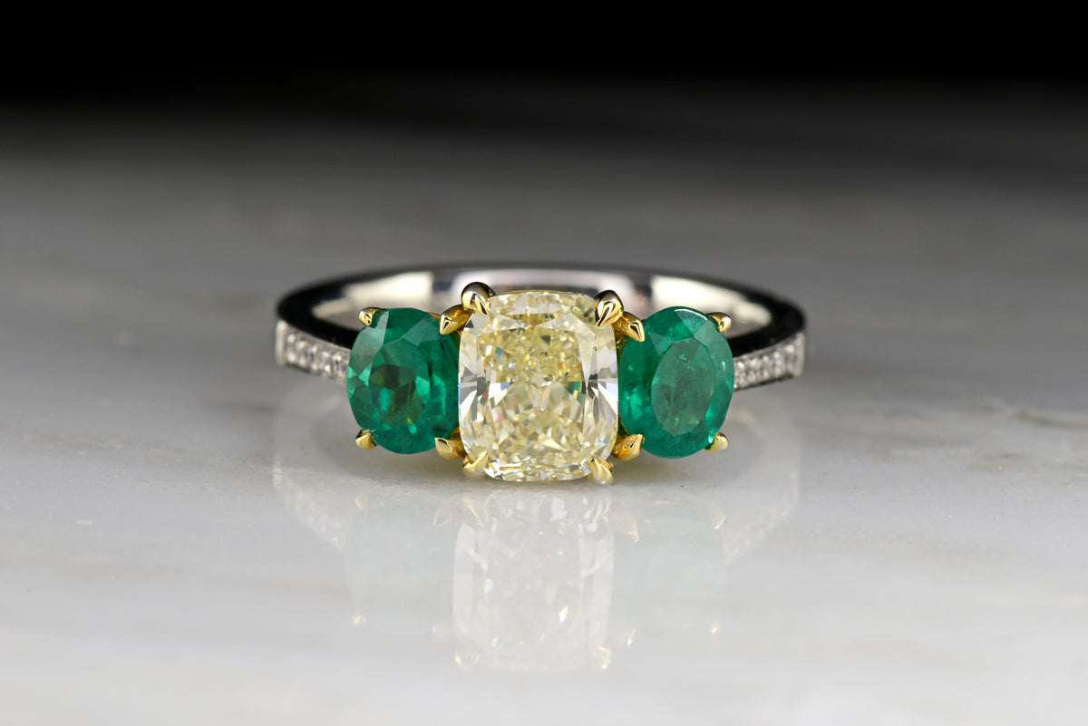 Vintage &quot;Henri Daussi&quot; Engagement Ring with 1.20 Carat Radiant Cushion Cut Light Yellow Diamond and Oval Cut Emeralds