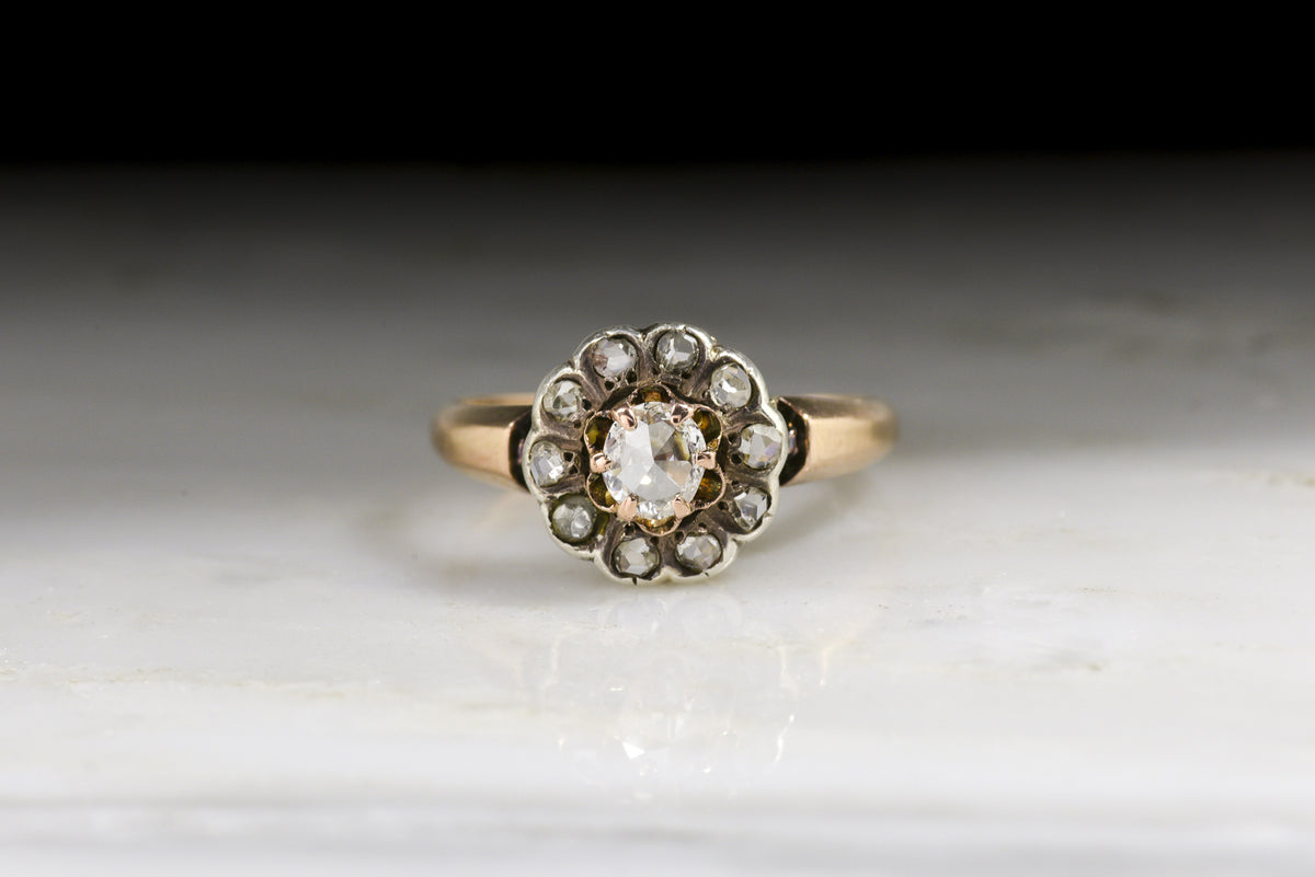 Antique Victorian Engagement or Promise Ring: Halo/Cluster Design with an Oval Rose Cut Diamond Center and Early Rose Cut Diamond Accents