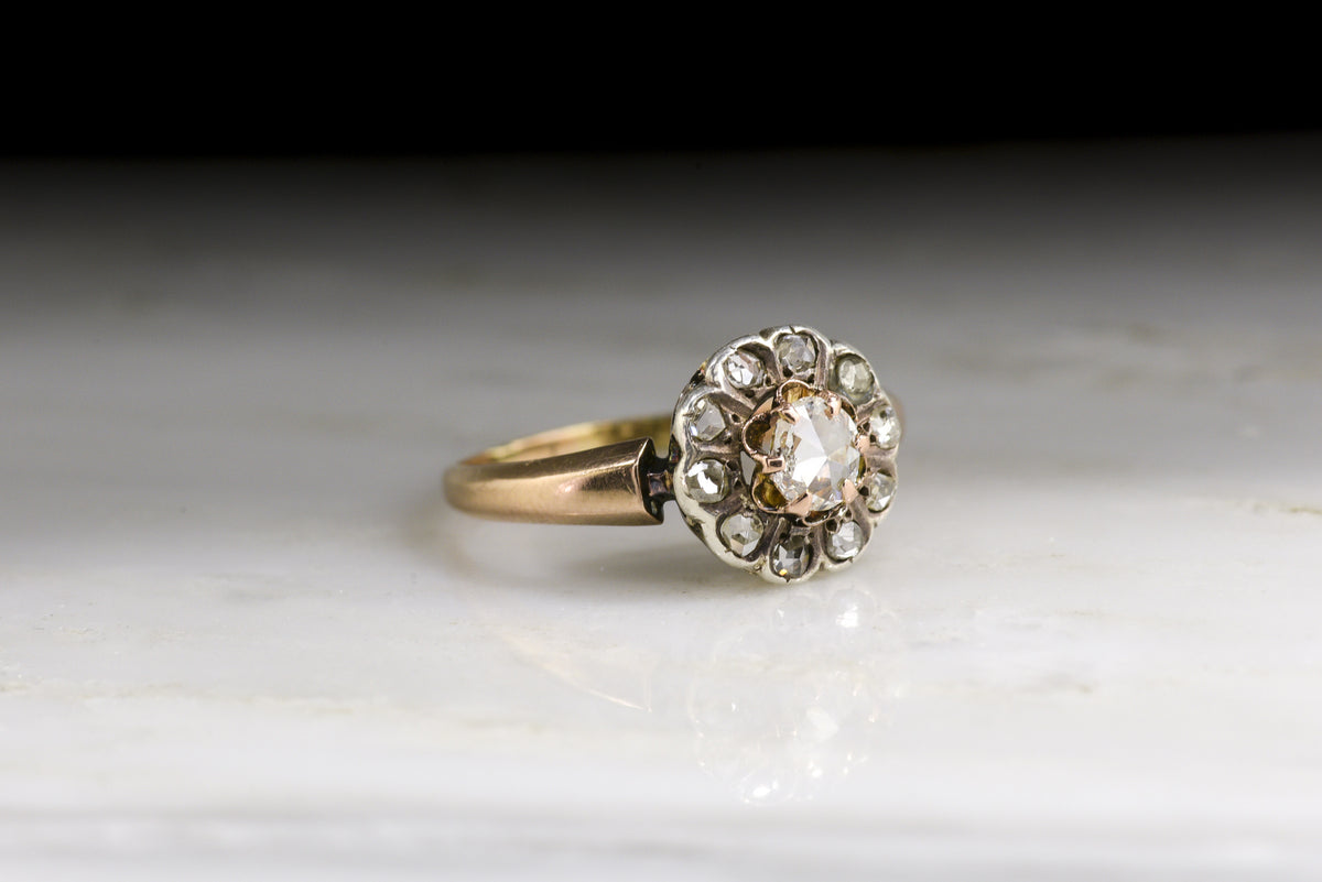 Antique Victorian Engagement or Promise Ring: Halo/Cluster Design with an Oval Rose Cut Diamond Center and Early Rose Cut Diamond Accents