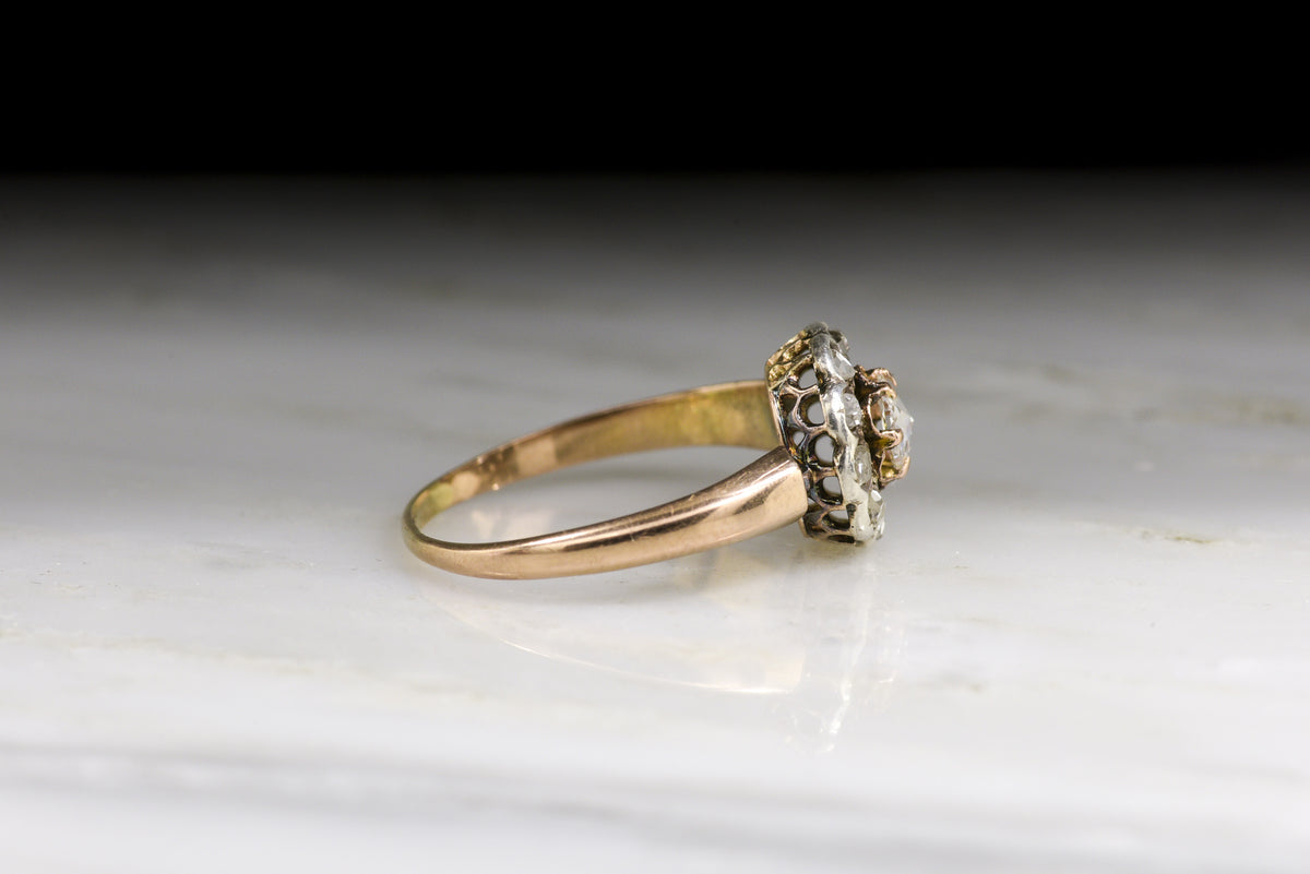 Antique Victorian Engagement or Promise Ring: Halo/Cluster Design with an Oval Rose Cut Diamond Center and Early Rose Cut Diamond Accents