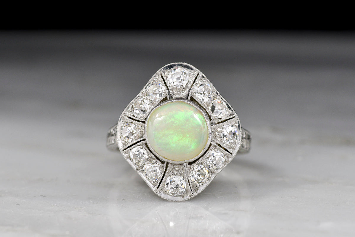 c. 1900-1910s Edwardian Dinner Ring with an Opal Center and Old Mine Cut Diamond Accents