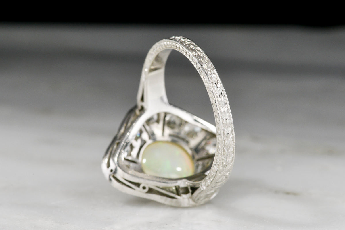 c. 1900-1910s Edwardian Dinner Ring with an Opal Center and Old Mine Cut Diamond Accents