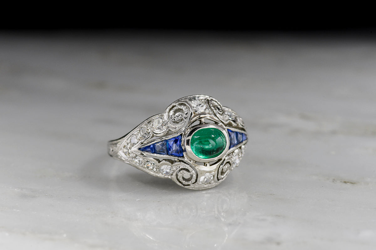 Art Deco Dinner Ring with an Emerald Center, Sapphire Sides, and Diamond Surround