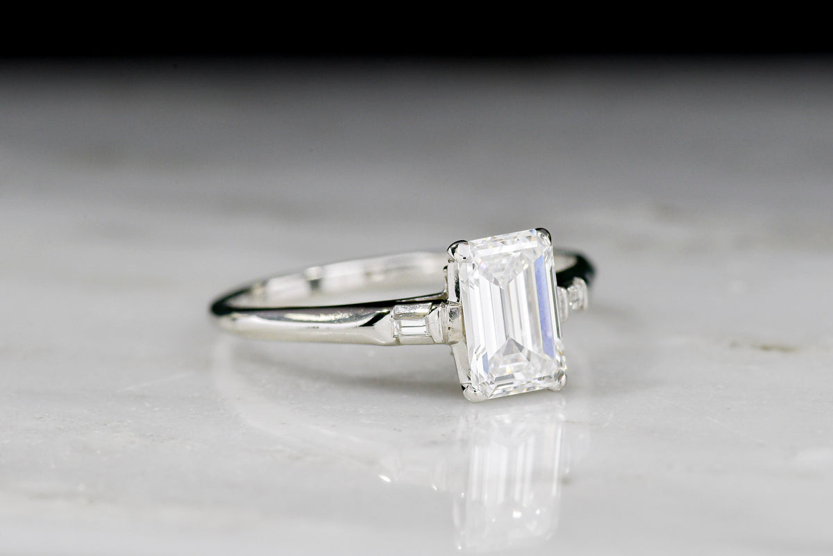 Midcentury Platinum Engagement Ring with an Emerald Cut Diamond Center and Baguette Shoulders