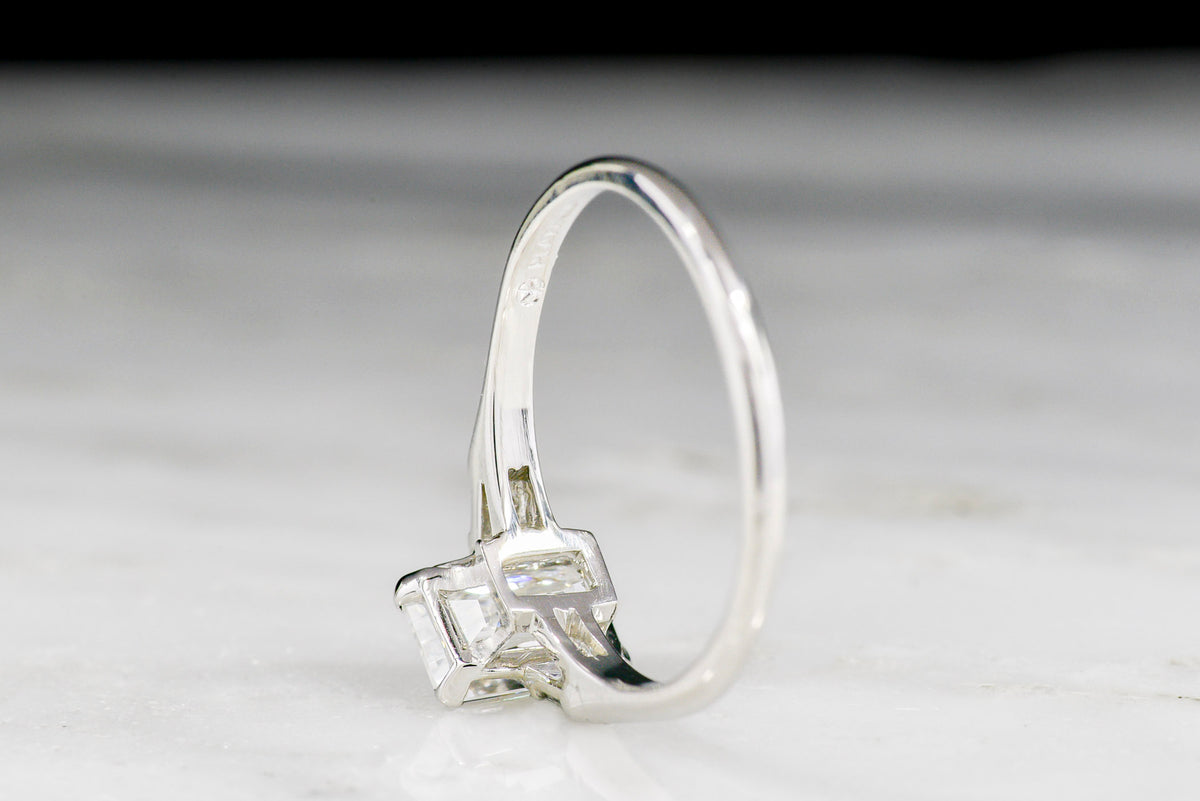 Midcentury Platinum Engagement Ring with an Emerald Cut Diamond Center and Baguette Shoulders